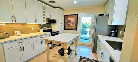Kitchen back door opens to side yard and laundry room
