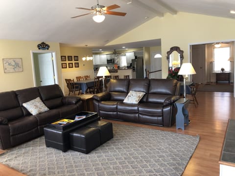 Large bright living room with tons of seating and leather sofas with Recliners
