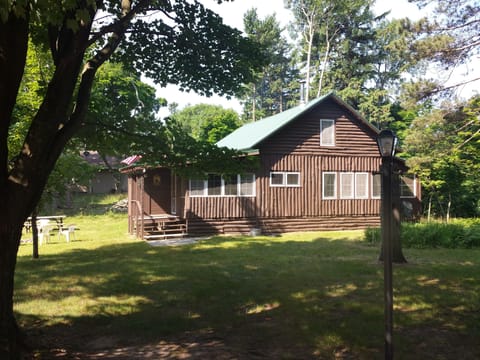 View of cottage at end of long driveway 