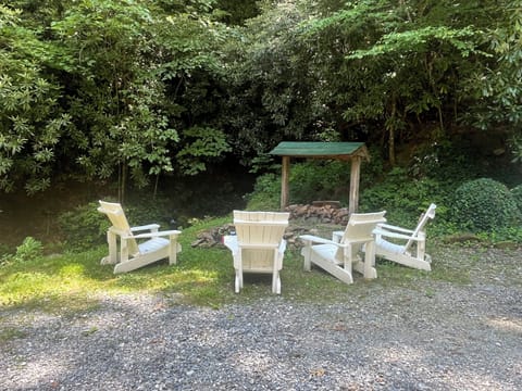 The fire pit next to the rushing stream.