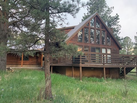 Front of home with covered walk and garage on the left