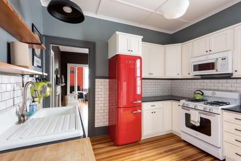 Second kitchen w/ vintage sink, Smeg refrigerator, and gas stove