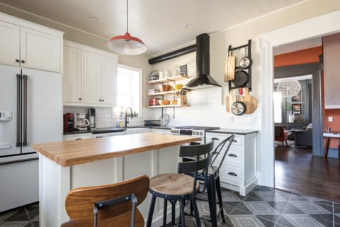 Primary kitchen with 6-burner gas stove and farmhouse sink