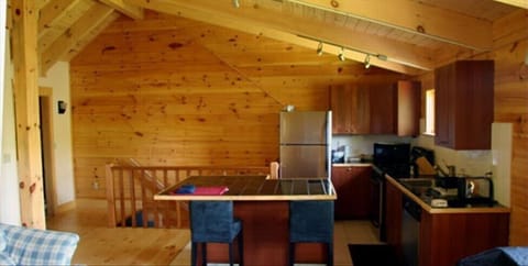 KITCHEN, CHERRY RAILING, LAUNDRY AT LEFT. MOST OF THE WOOD IS FROM OUR FOREST!