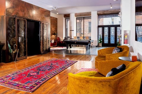 Chic Sitting Space Adjacent to Wet Bar and Elevator