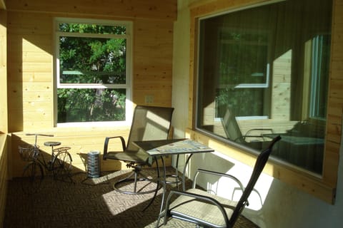 Tongue and groove sun porch with lots of sunlight.
