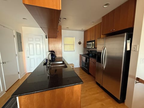 Front entry way, half bath/laundry, kitchen