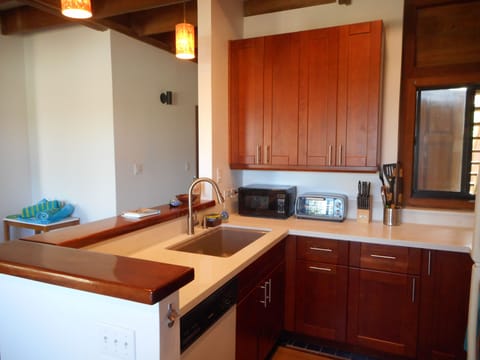 Beautiful wood cabinetry, deep cast iron sink, smooth quartz countertops.