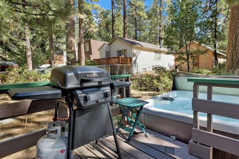 Private outdoor hot tub, propane BBQ surrounded by tall pines, perfect for relaxing under the trees after a day of adventure—enjoy peaceful forest views, fresh air, and a truly rejuvenating stay.