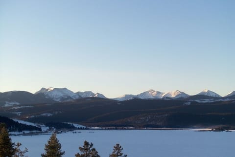 The cabin offers an expansive view of the lake and Pintlers from the living area