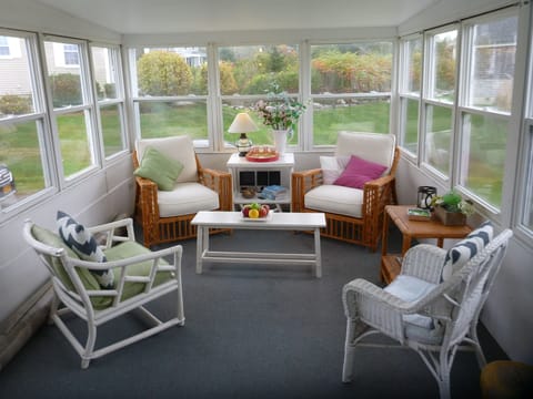 Screened porch offers ocean breezes, songbirds in the meadow, cocktails?