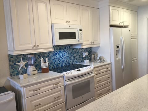 Glass opalescent tile reflects the colors of the Caribbean view outside the door