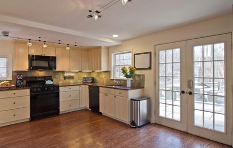 The newly-remodeled + fully-equipped kitchen opens onto a blue stone patio.