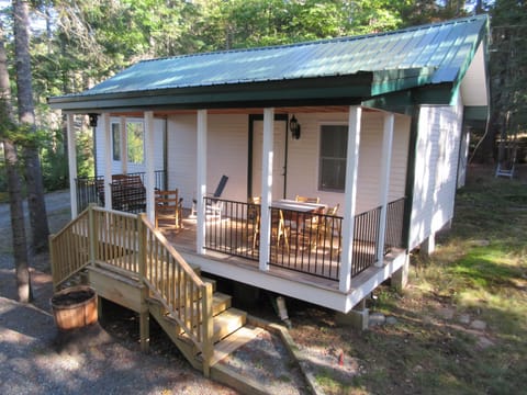 The front porch of the Kerr Cottage with sitting area & game/puzzle table