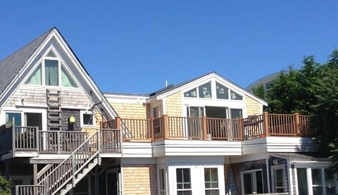 Top 2 floors of this old Captain's house. Deck spans across length.