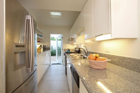 Updated kitchen w/ stainless appliances and granite countertops. Door to garden.