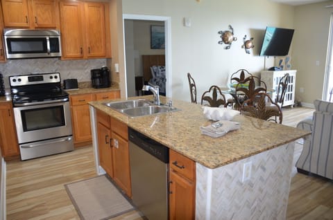 Fully stocked kitchen with Kerig coffee maker, blender, microwave, toaster