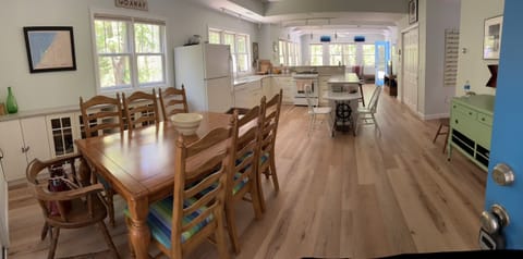 Dining area adjacent to the kitchen. Table seats 8. Space at the bar seats 8 too