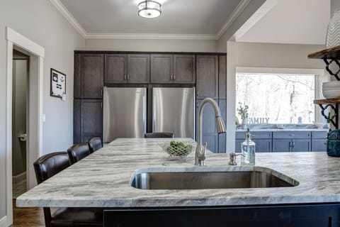 Kitchen features two refrigerators and freezers with two ice makers.