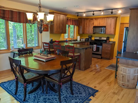Large dining room table, full kitchen, and dedicated desk/workspace