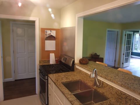 Another view of kitchen showing granite sink counter and breakfast counter
