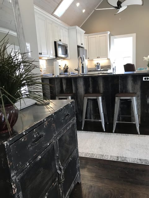 View into the kitchen from living room with barn wood   framed bar