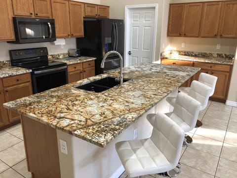 Spacious kitchen island equipped with stools.