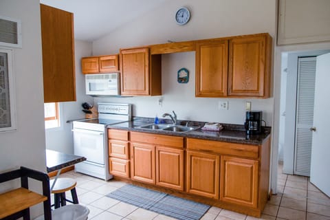 Kitchen with stove, microwave and refrigerator.