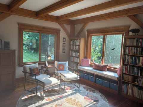 Library area  between TV room and sunroom.  Desk, chairs,  and full bookshelves.