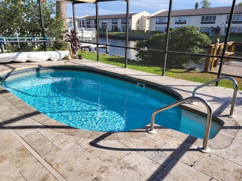 Private screened-in, heated pool with pool deck/sidewalk to dock & pontoon boat.