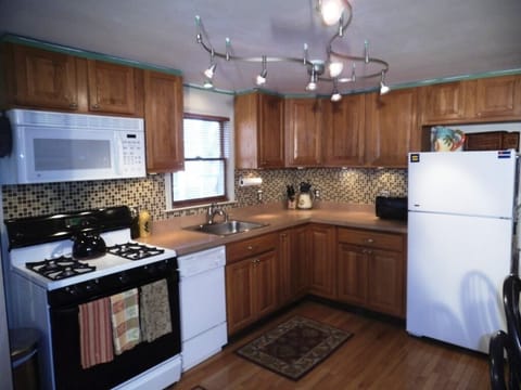 Kitchen w/microwave, toaster oven, coffee maker,cups, plates, utensils, pans.