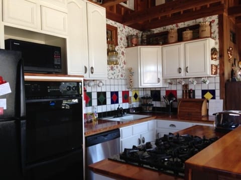 Gourmet kitchen with double ovens and 5 burner gas range