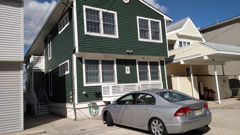 Back of house with 1 designated parking spot.