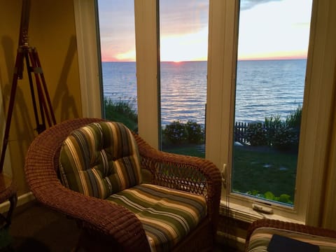 One of 4 chairs with ottomans along the window wall. Book readers delight.