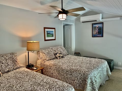 Upstairs loft bedroom has 2 double beds, AC & ceiling fan & attached bathroom.