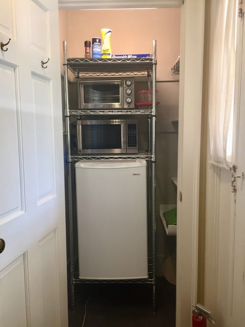 Pantry: Convection oven, microwave, refrigerator, coffeemaker, and dishes.
