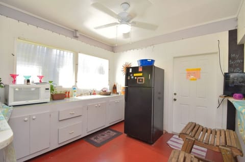 kitchen area in game room with fridge & microwave