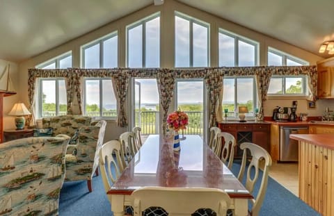 Living, dining, kitchen area has doors to deck for outdoor eating, entertaining.