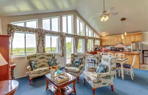 Living, dining, kitchen area has doors to deck for outdoor eating, entertaining.