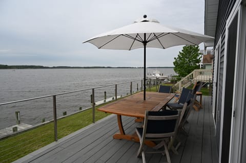 Sundeck (Teak Furn:  Banquet Table, navy slingback chairs & Sunbrella looking NE