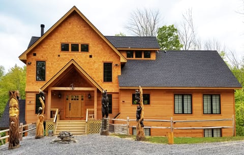Main entrance with custom totem carvings and fire feature