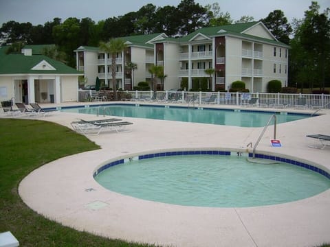 Pool Area with Lounge Chairs and restrooms
