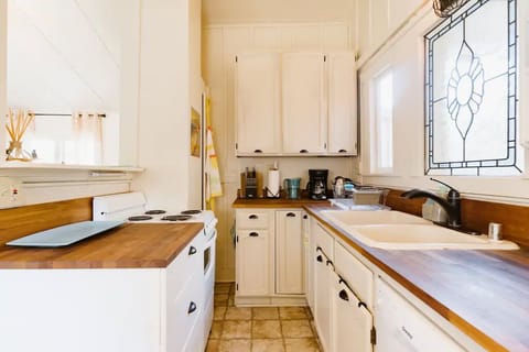 Small stove, coffee maker, pots, pans, and more.