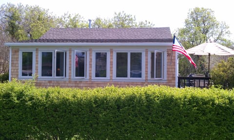 Front of house has a wall of glass windows