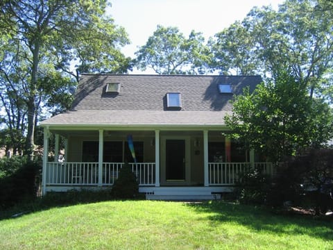 House nestled in shady lot.