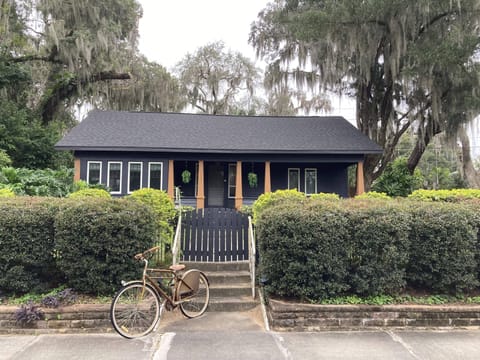 we have a black house with an old bike parked out front