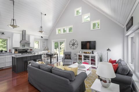 Full view of open living space and unique ceiling and windows