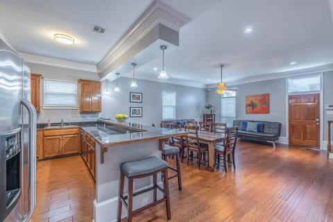 Side view of kitchen with wrap around bar and drop lighting