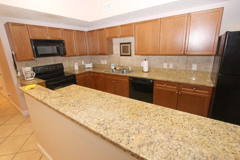 Fully stocked kitchen with two fridges.