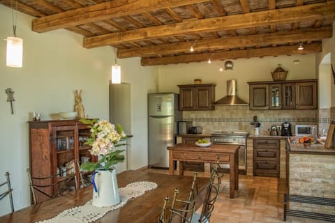 The very large custom built kitchen with old pizza making table and dining table